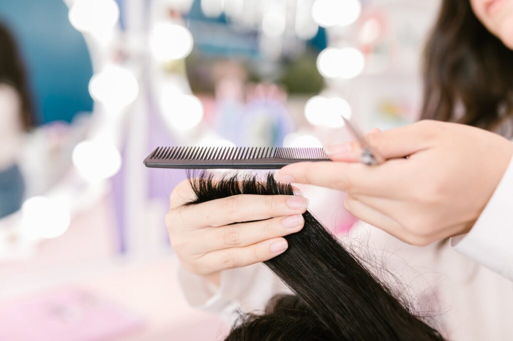 hands holding hair and comb